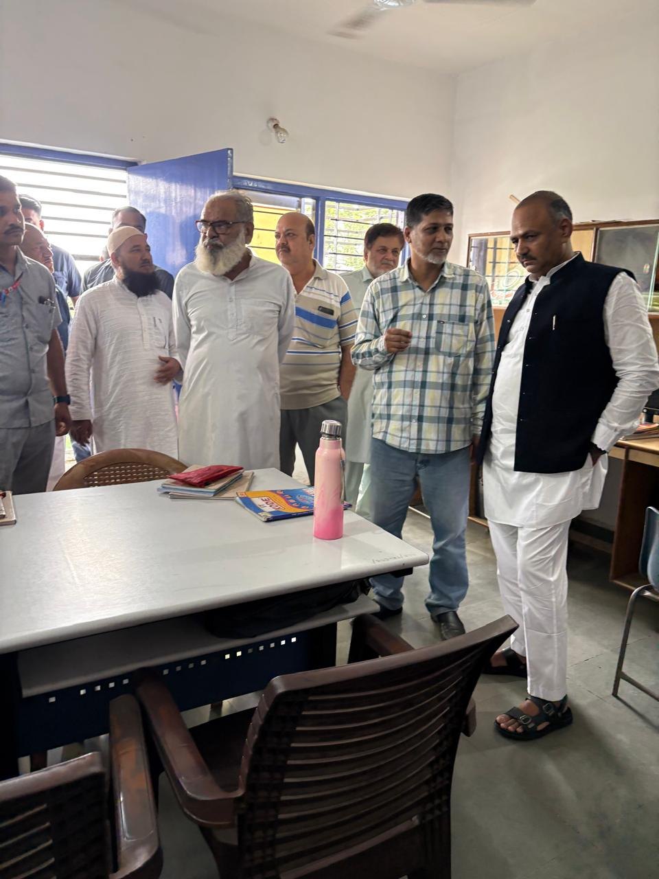 Waqf Chairman visit with school representatives in a classroom