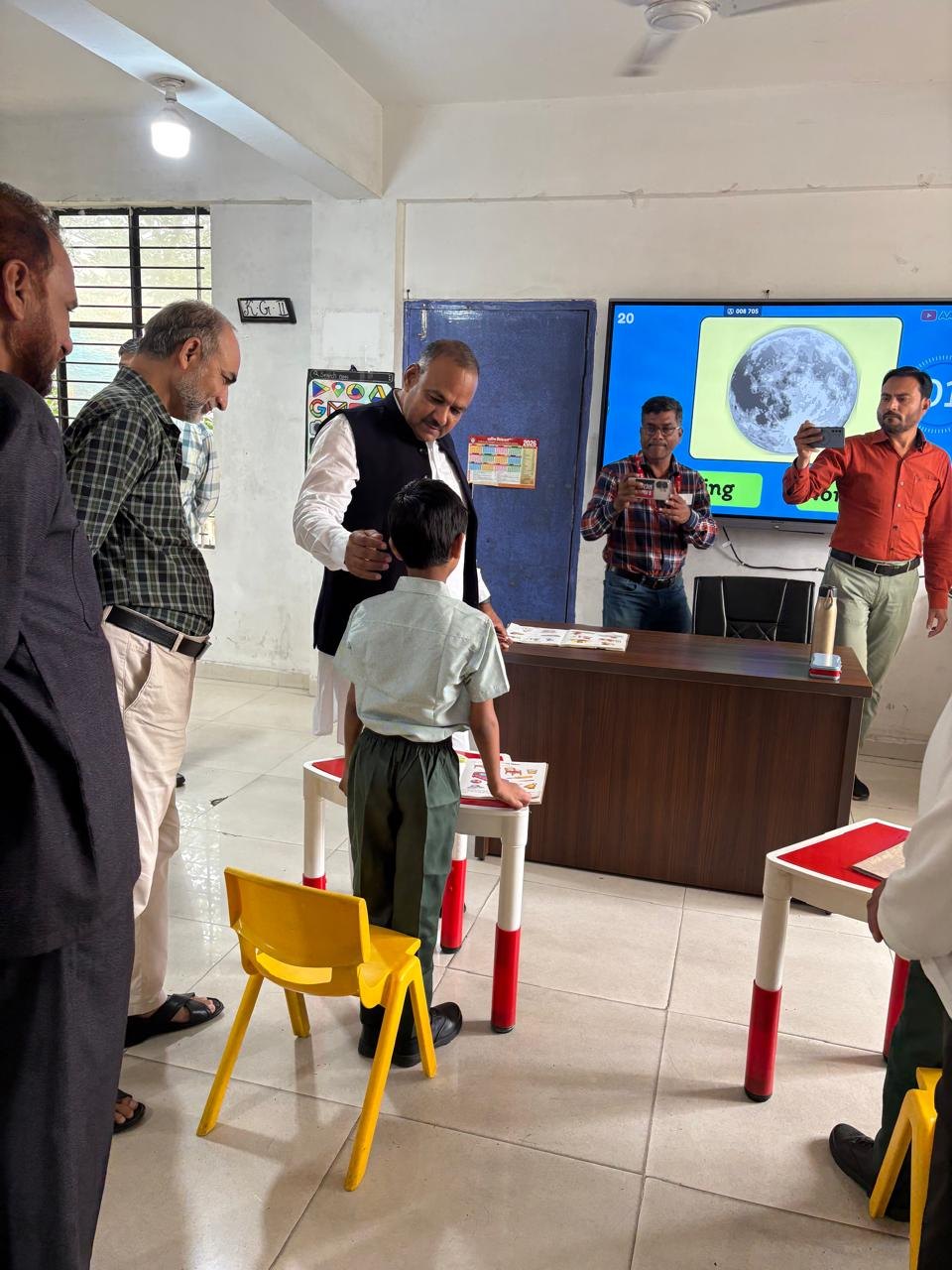 Waqf Chairman interacting with a student during the school visit